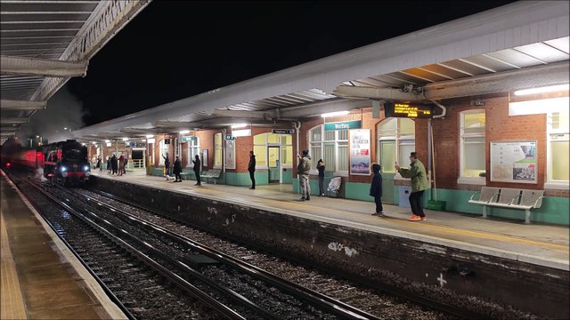 Steam train looking majestic alongside modern train at Worthing railway station