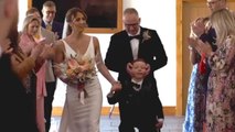 Little boy beats odds to walk mum down aisle thanks to special harness