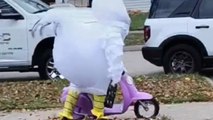 Neighbor spreads Halloween cheer in a chicken costume while scooting around