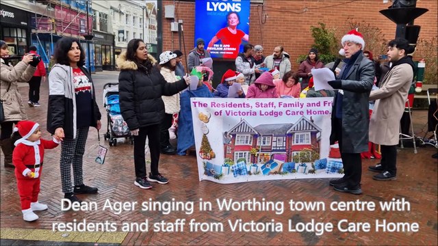Dean Ager singing in Worthing town centre with residents and staff from Victoria Lodge Care Home