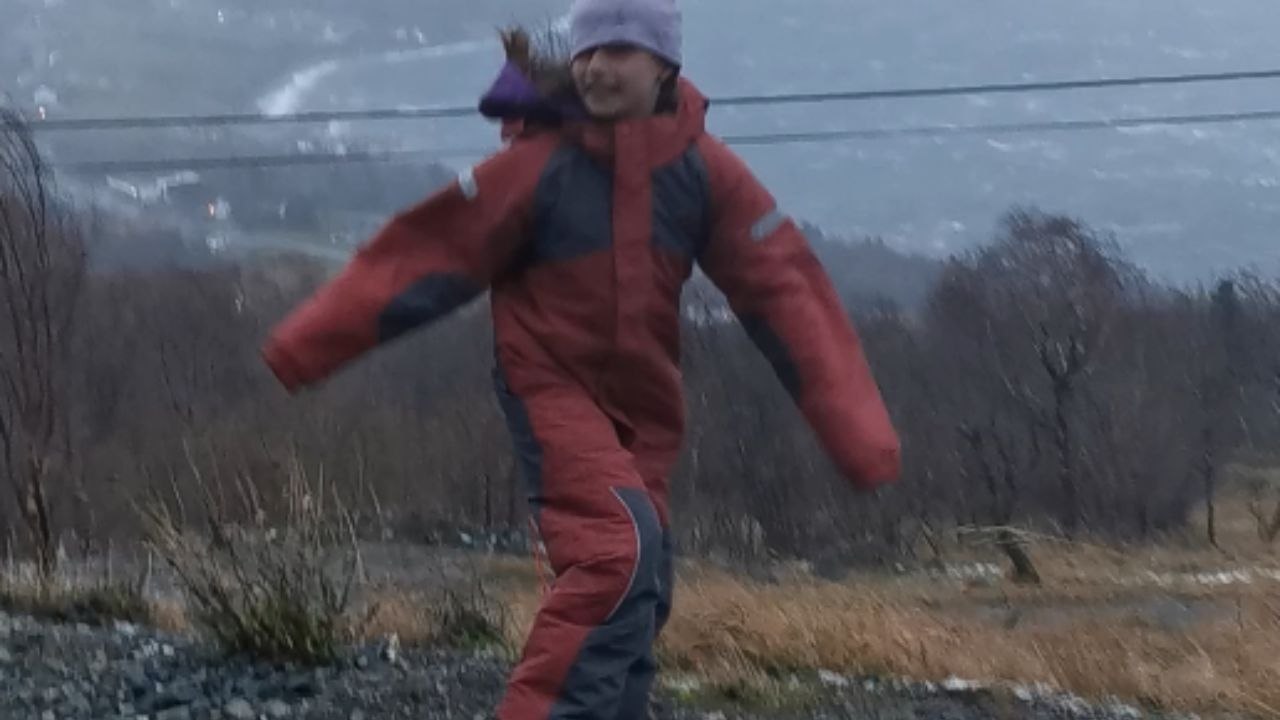Stormy Saturday in Norway sees strong winds challenge a girl trying to hold her ground
