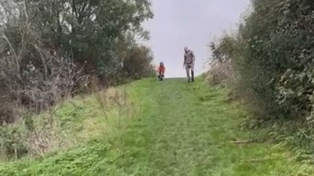 Young rider loses control of balance bike while cycling down steep hill