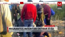 Decenas de migrantes intentan entrar a EU por Ciudad Juárez; les disparan gas pimienta