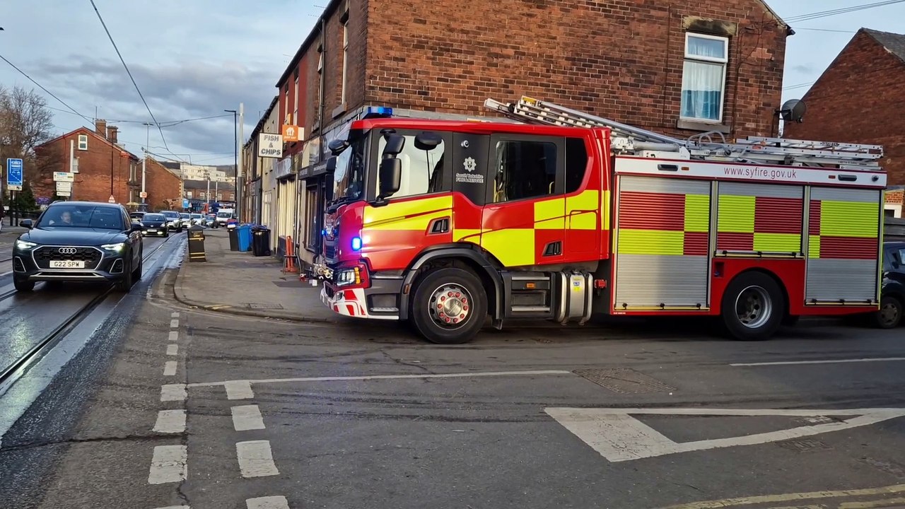 Firefighters at the scene after a blaze broke out at a chip shop near Hillsborough
