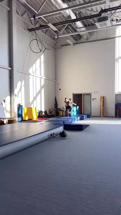 Athlete Places Block From One Platform to Another While Doing Front Flips