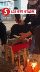 China Daily | Beating 'villains' rites in Wan Chai