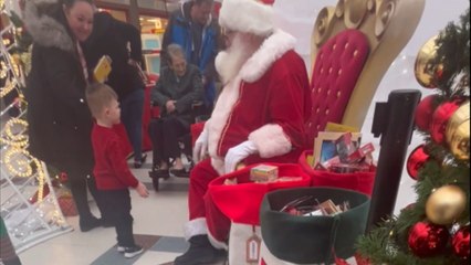 Santa Claus receives an unexpected present from an adorable little girl