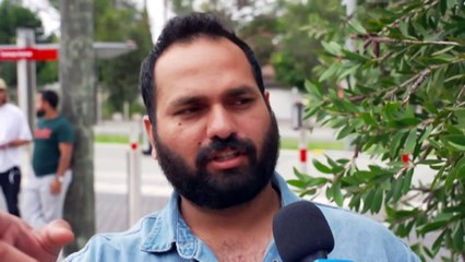 Police questioning a man after a woman falls from a balcony