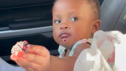 Annoyed baby girl redirects mom’s attention from berries to water