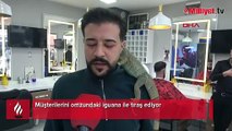 Müşterilerini, omzunda iguana ile tıraş ediyor