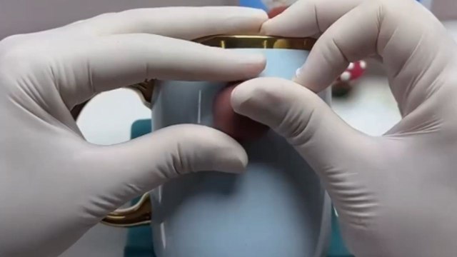 Artist sculpts little witch riding her broomstick on a mug using polymer clay