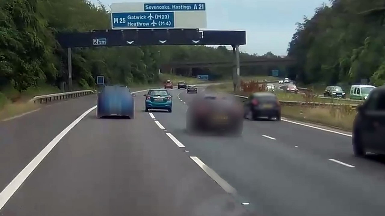 Moment a driver sweves his car on the M25 and into oncoming traffic ...