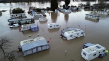 Caravans submerged in floodwater at holiday park