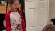 Santa leaves hidden Christmas presents behind the door for kids