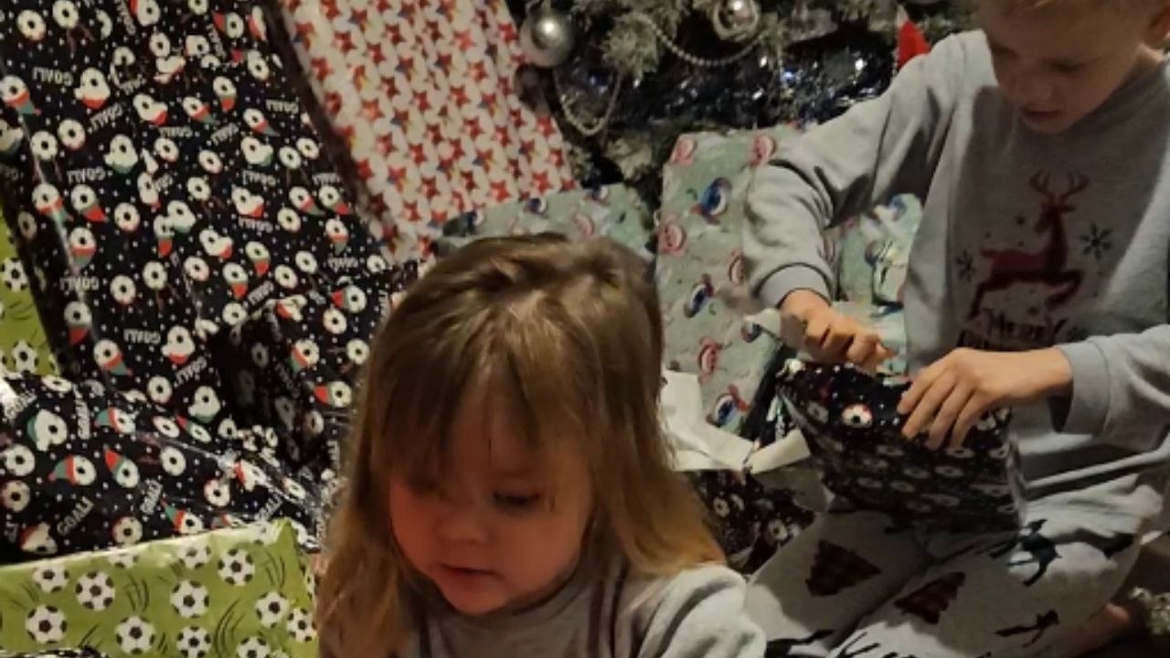 Little girl unwraps gifts and cracks the code on Santa’s shopping secrets