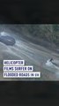 Helicopter films surfer on flooded roads in UK