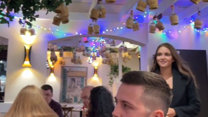 Girl returns from travel and surprises dad and boyfriend with a Christmas hug