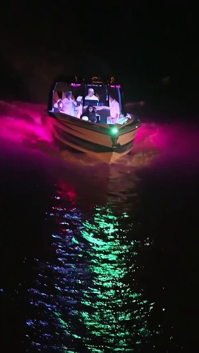 AMP Power Boat after dark from the bridge over the Haulover Inlet