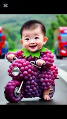 Cute baby play with red grapes motor cycle