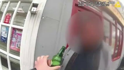 Man swigs his lager while being arrested for drink driving