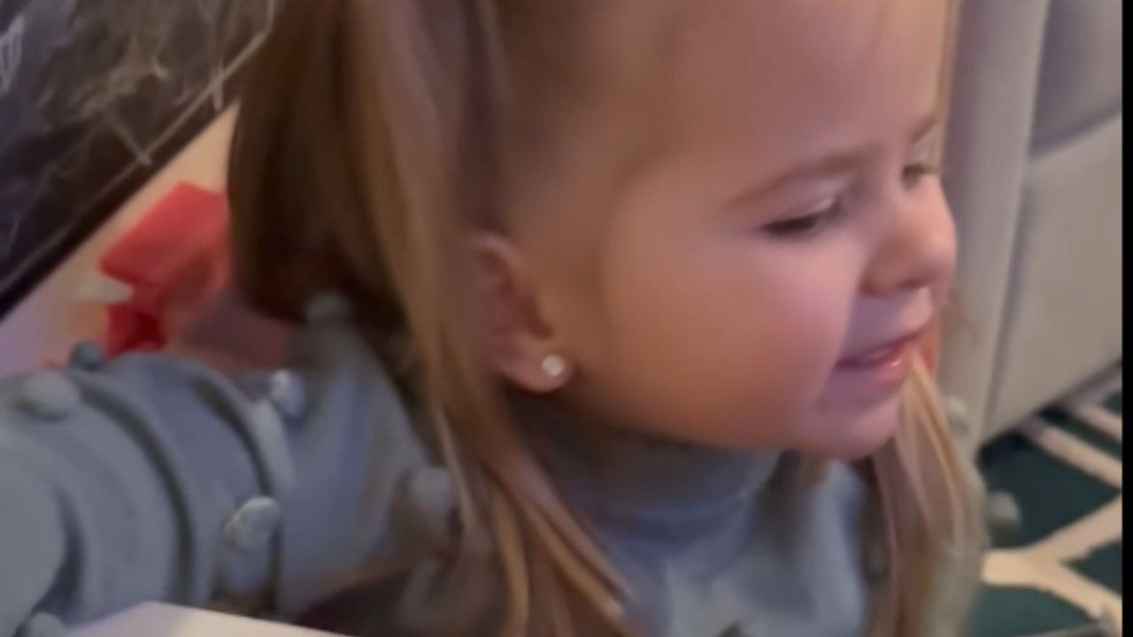 Wholesome fun: Little girl makes the best of being stuck in a toy bus