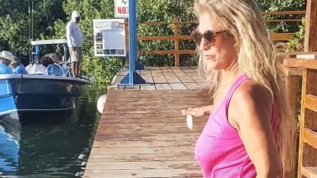 Woman's pursuit to feed fish during Caye Caulker vacation sparks a cool moment