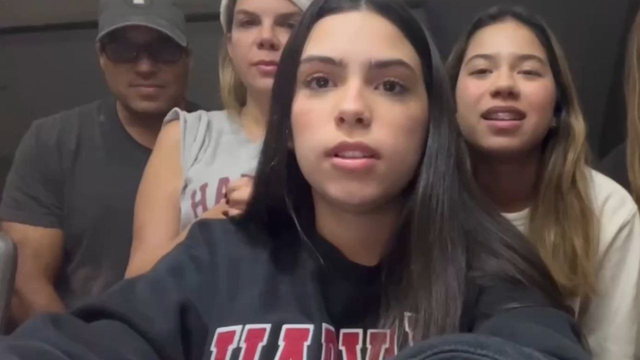 Girl checks her Harvard College application status with loved ones by her side