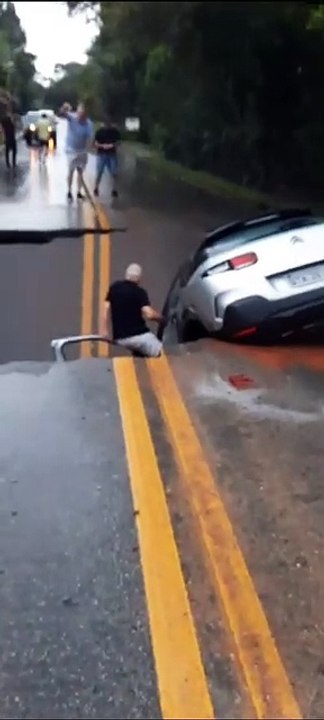 Cratera se abre, carro fica pendurado e motorista é "içado" em estrada de Florianópolis