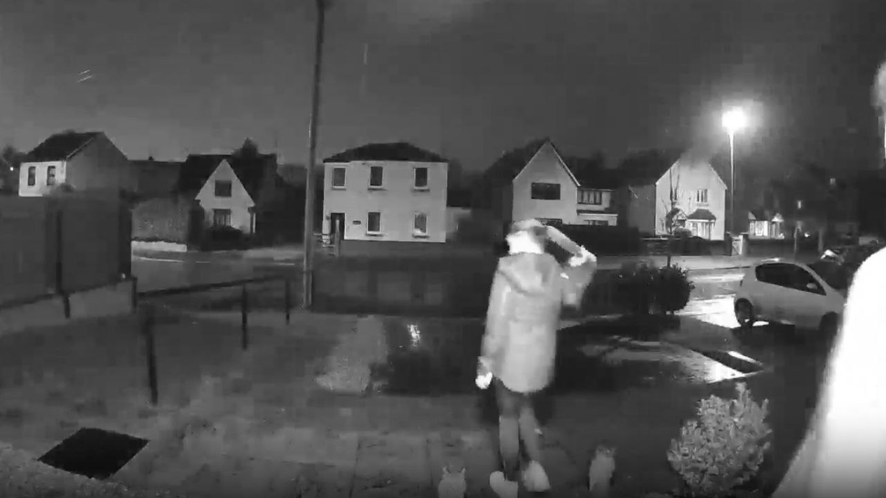Doorbell camera records two girls slipping and falling on a slippery winter night