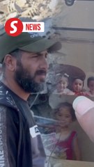 'All I want is a grave from them,' says Gazan whose family remains under the rubble