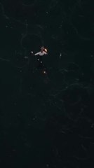 Woman Dances Gracefully on Ice, Holding Fire Sticks in Her Hands
