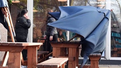 Staff from the Quarry Kitchen and Cafe Bar, Shrewsbury, battle with an unruly table brolly in the high winds!