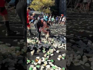Dog Drinks Water From Glass While Running in Marathon
