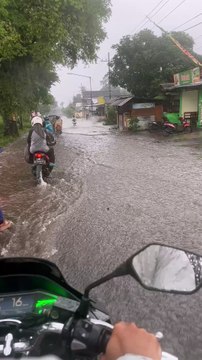 Rider's bike ride through a flooded road took an unexpected splashy turn