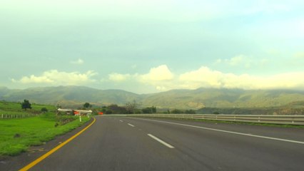 Scenic highway with mountains and open sky