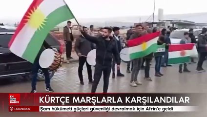 Şam hükümeti güçleri güvenliği devralmak için geldiği Afrin'de davul ve Kürtçe marşlarla karşılandı