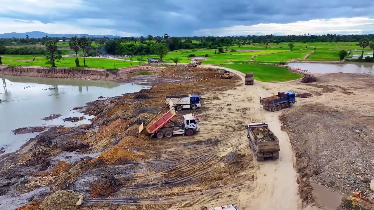 Nice Processing Dump Truck Transports Dust Into Deeply Large Pond and Bulldozer Push Stone