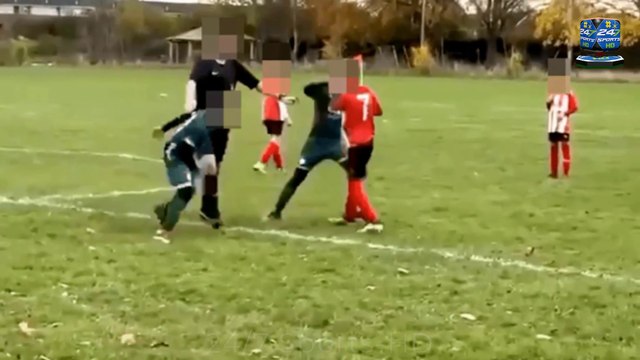 Shameful footage shows man KICKING boy at under-10s football match as parents break into mass brawl while mothers scream for their children
