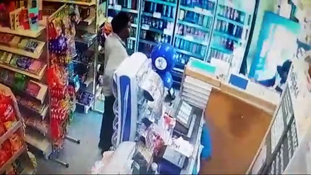 Axe-wielding robber threatens shopkeeper before brave wife fights back