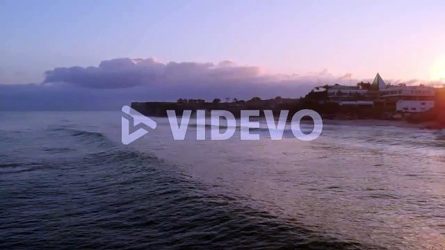 Uluwatu bali island surfer spot, aerial view of waves in clean water ocean at sunset
