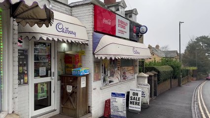 Hero shopkeeper hands over bread, butter and milk to hungry robber with knife