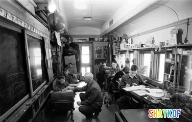 Teacher Fred Sloman teaches a lesson on a school train. 1954, Canada.