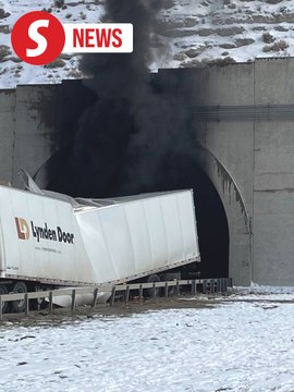 Investigators enter a highway tunnel in Wyoming where a fiery crash killed two