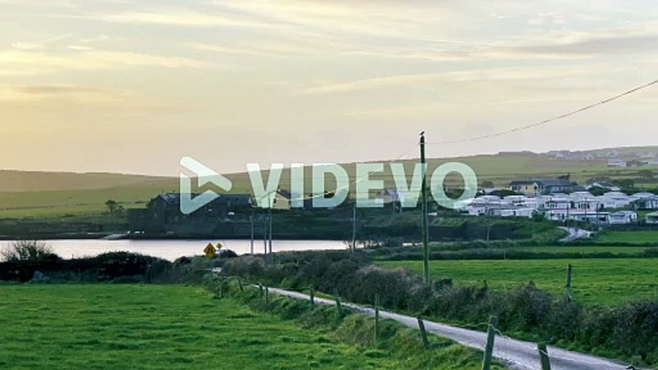 Early morning with winter sunrise over coastal road and village in West Cork, Ireland