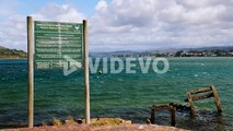 Garden Route National Park warning and indemnity board on edge of Knysna Lagoon