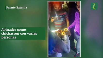 Abinader come chicharrón con varias personas