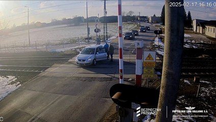 Stalled car pulled off level crossing just before express train arrives