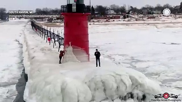 Lighthouse perches atop frozen shores of Lake Michigan