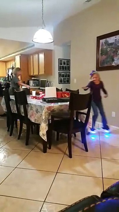 Child Wobbles on Hoverboard Indoors and Takes Tumble