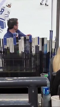 The _stick man_ at NHL games keeping his hand on the stick of their player with the puck.